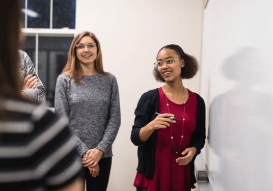 A young woman teaching a group